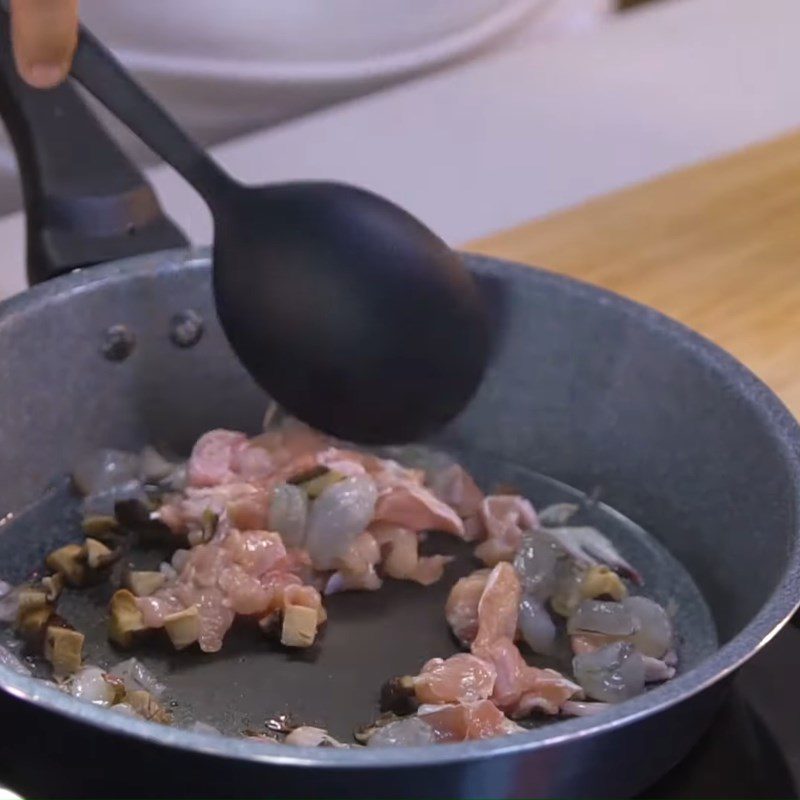 Step 2 Stir-fry shrimp and meat mixture and mix with rice Lotus leaf steamed rice