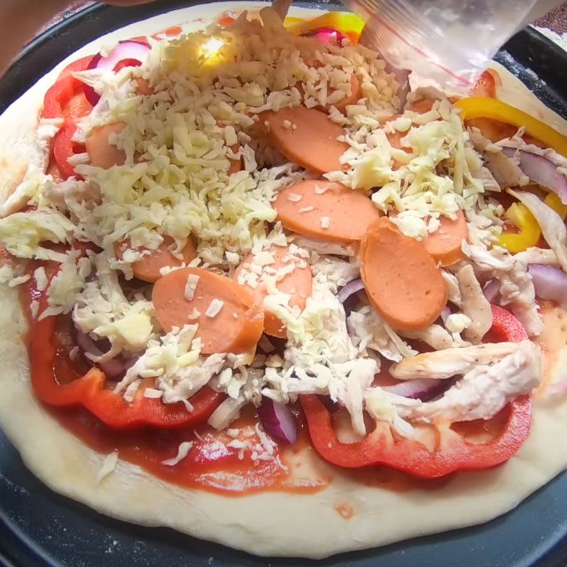 Step 4 Adding the filling to the chicken cheese pizza base