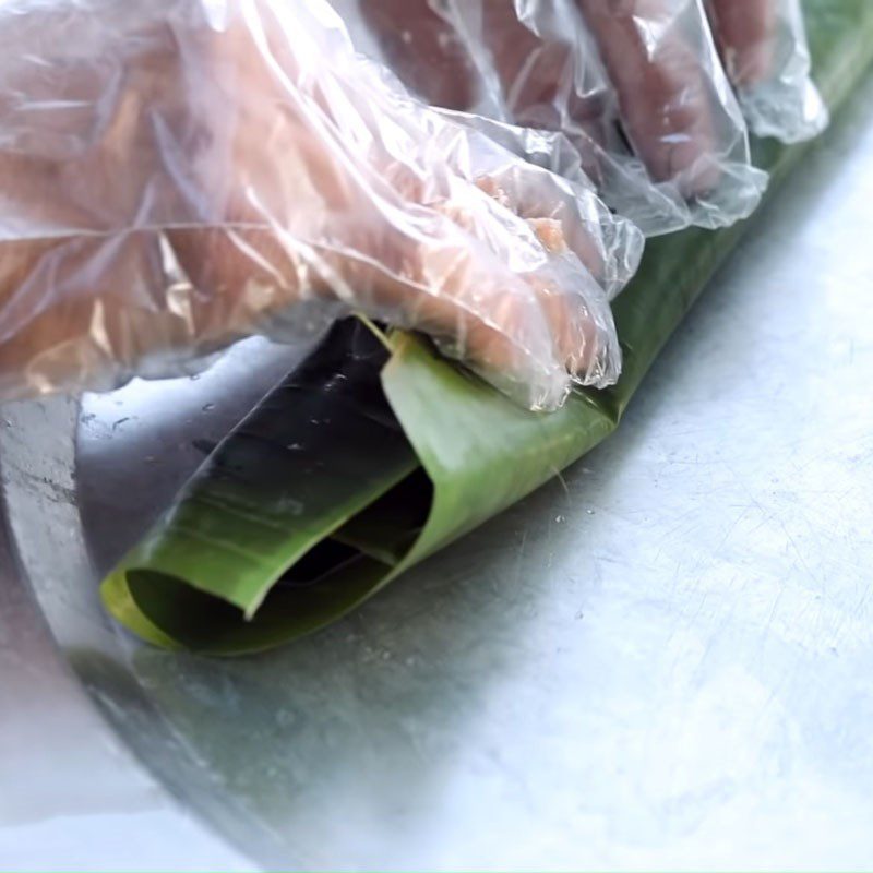 Step 4 Wrapping the sausage Grilled snail sausage wrapped in banana leaves
