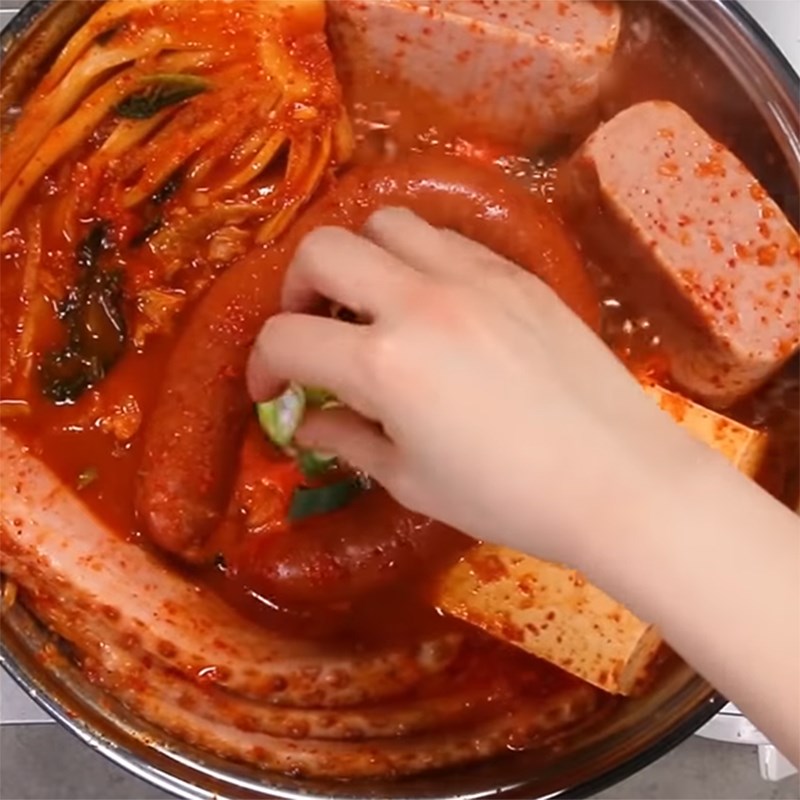 Step 2 Cooking kimchi sausage hot pot with ham