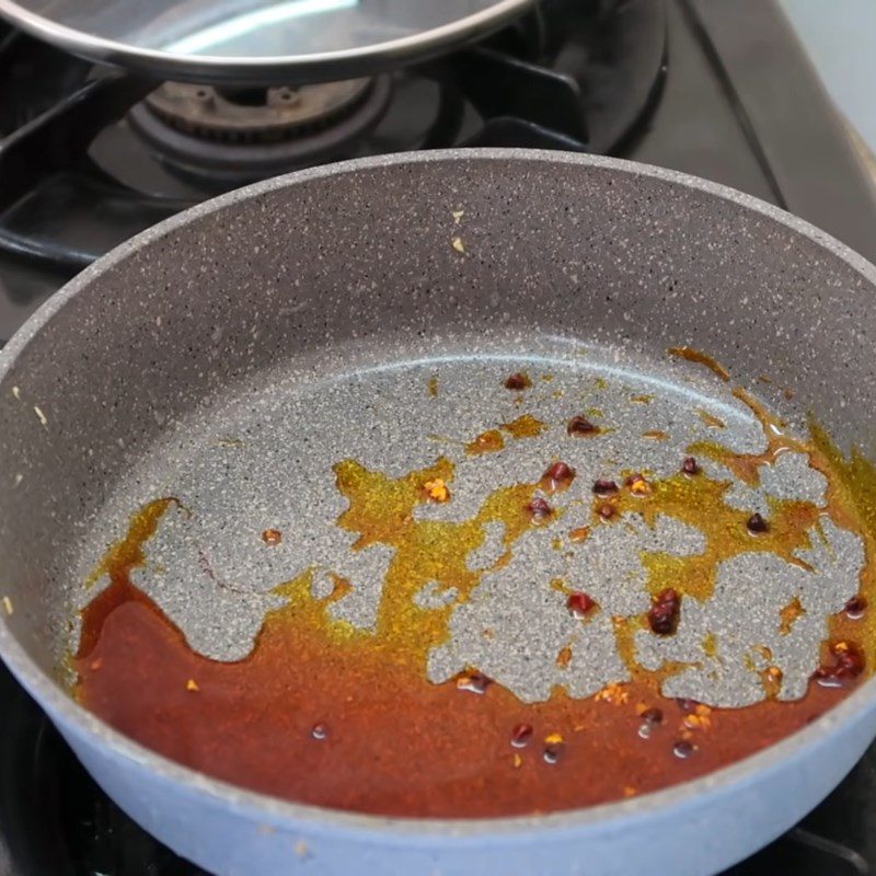 Step 2 Sauté garlic and prepare annatto oil for dried chicken using the oven