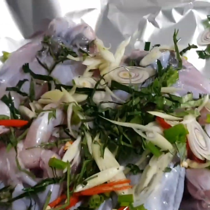 Step 2 Place the frog and ingredients on the foil Frog mixed with lolot leaves wrapped in foil