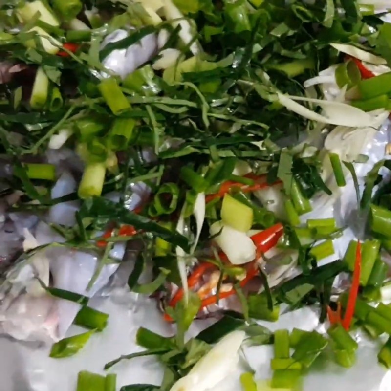 Step 2 Place the frog and ingredients on the foil Frog mixed with lolot leaves wrapped in foil