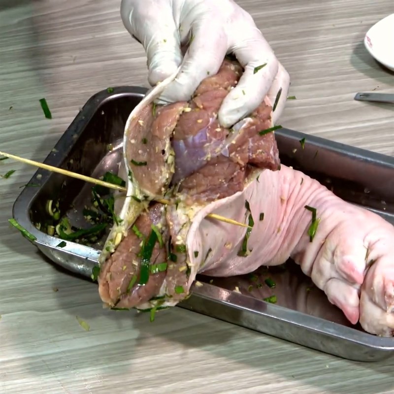 Step 4 Stuffing the Mắc Mật Leaves and Tying the Pork Leg Grilled Pork Leg with Mắc Mật Leaves