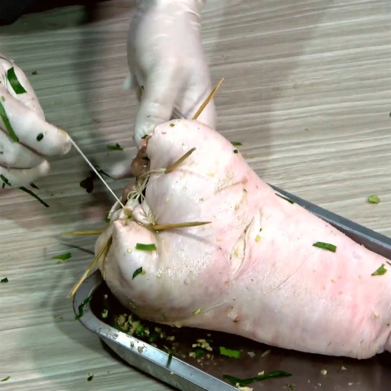 Step 4 Stuffing the Mắc Mật Leaves and Tying the Pork Leg Grilled Pork Leg with Mắc Mật Leaves