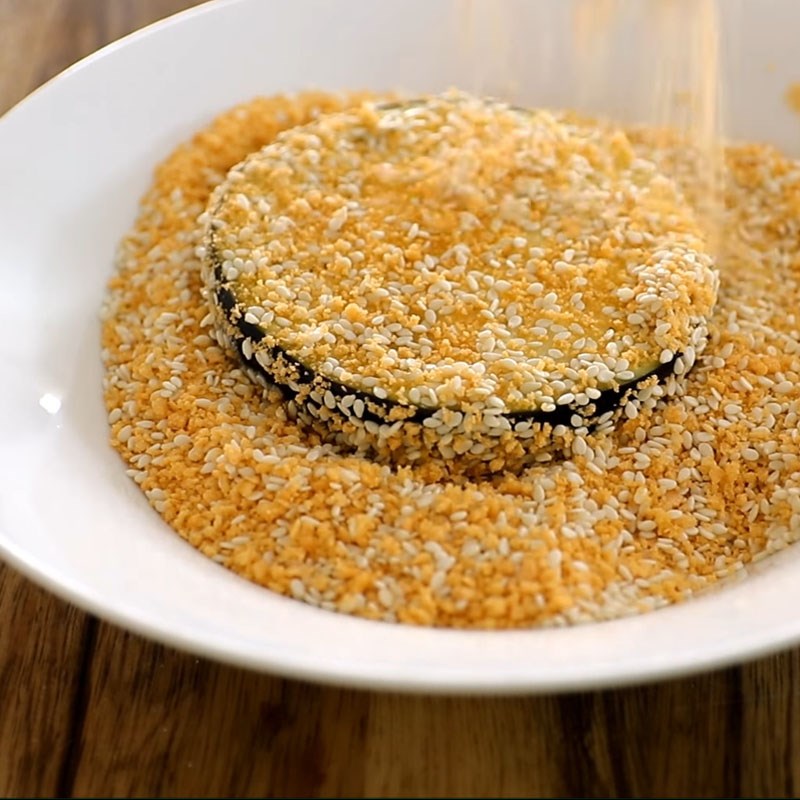 Step 3 Dip the eggplant in batter for crispy fried eggplant coated with sesame