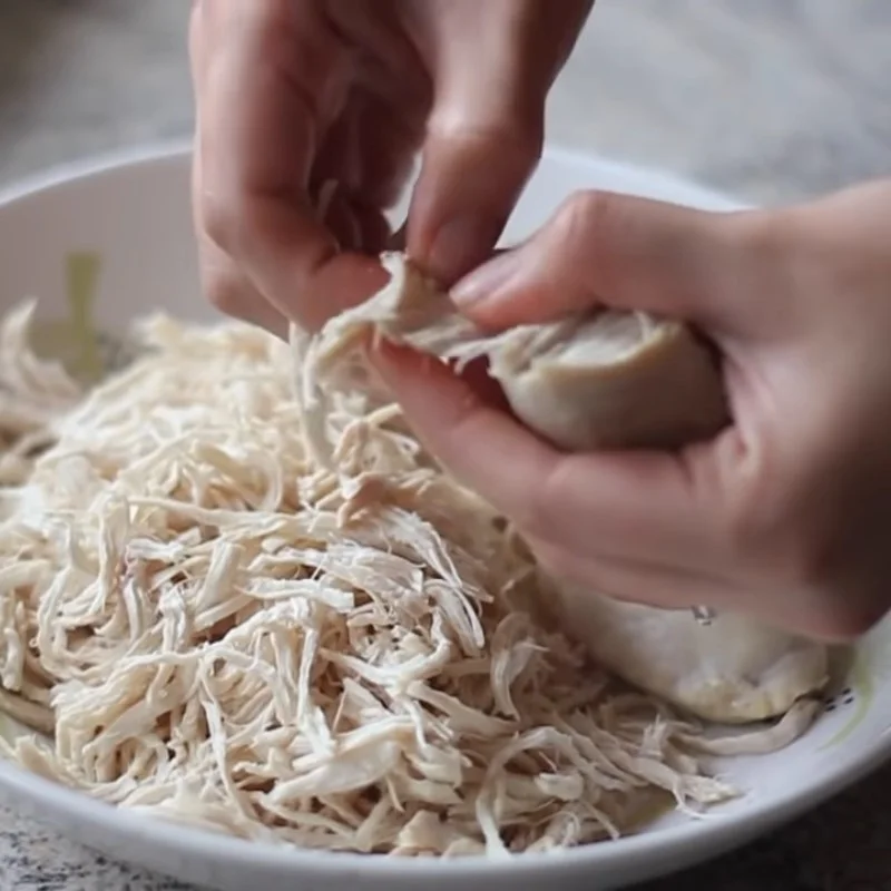 Step 1 Prepare, boil chicken and shred chicken Spicy Shredded Dried Chicken using a pan