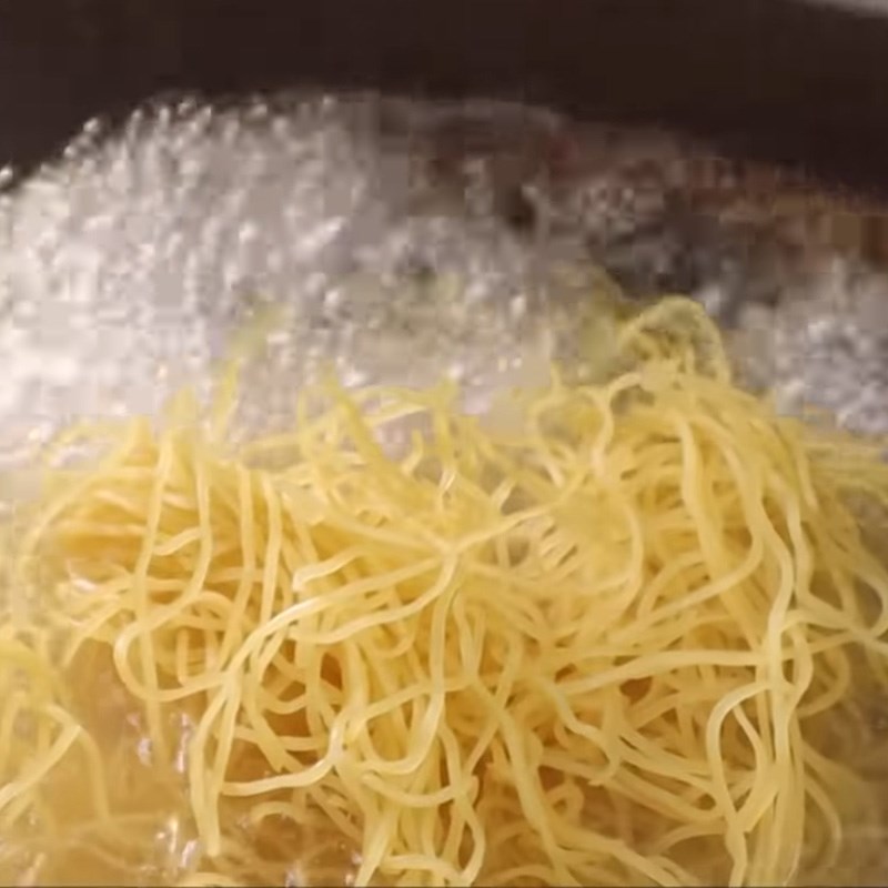 Step 7 Blanching the noodles Chicken noodles fried in a pan