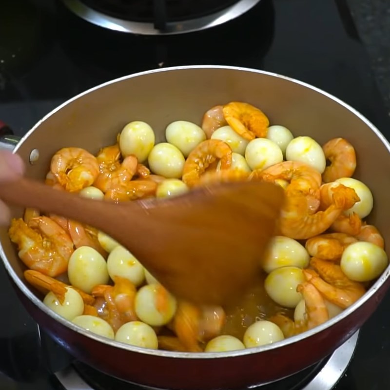 Step 6 Sautéing shrimp, quail eggs, and meat for Phu Chiêm Quang noodles